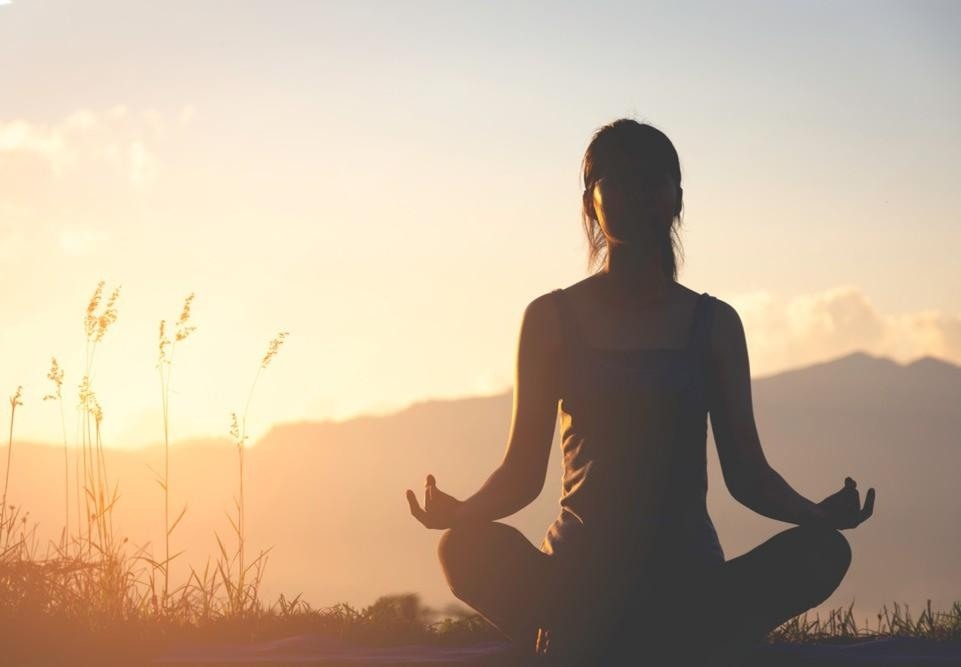 Hands cupping light in meditative gesture representing inner wisdom
