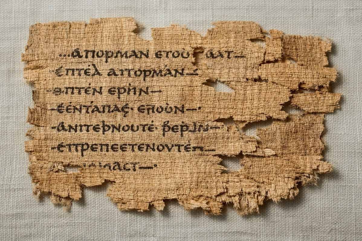 Ancient Coptic papyrus fragments from Nag Hammadi Codex XI showing the Allogenes text with faded script