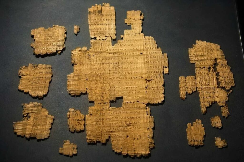 Severely damaged ancient papyrus fragments with barely legible Coptic script