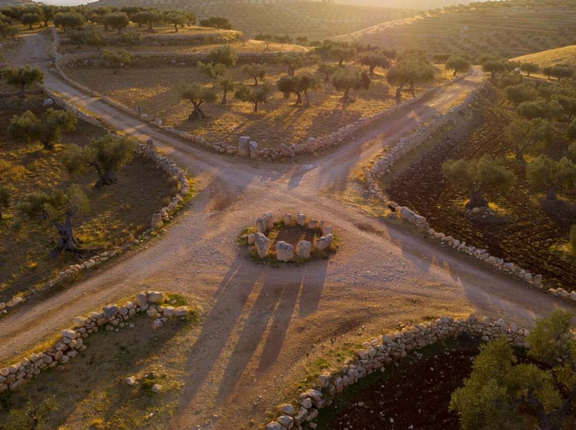 Four roads diverging from a central point in an ancient landscape, representing the fourfold apostolic mission