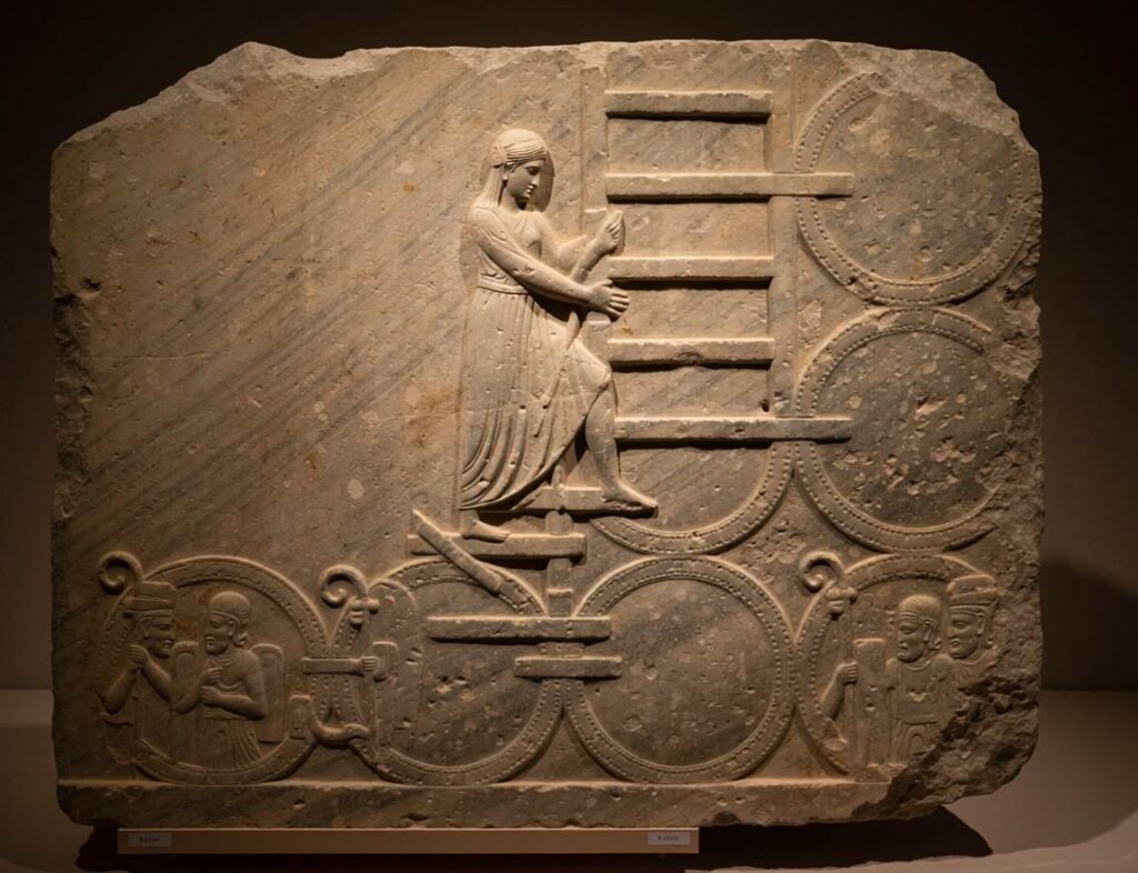 Carved stone relief showing the feminine soul ascending through seven planetary spheres with guardian figures
