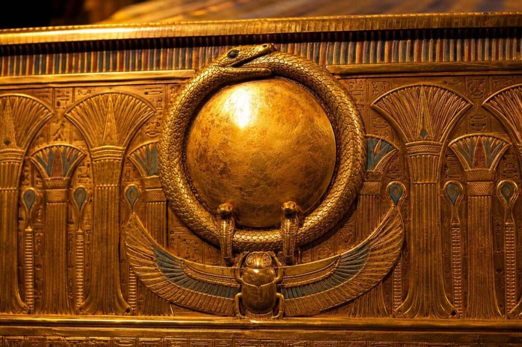 Golden ouroboros on Tutankhamun's shrine encircling the solar disc